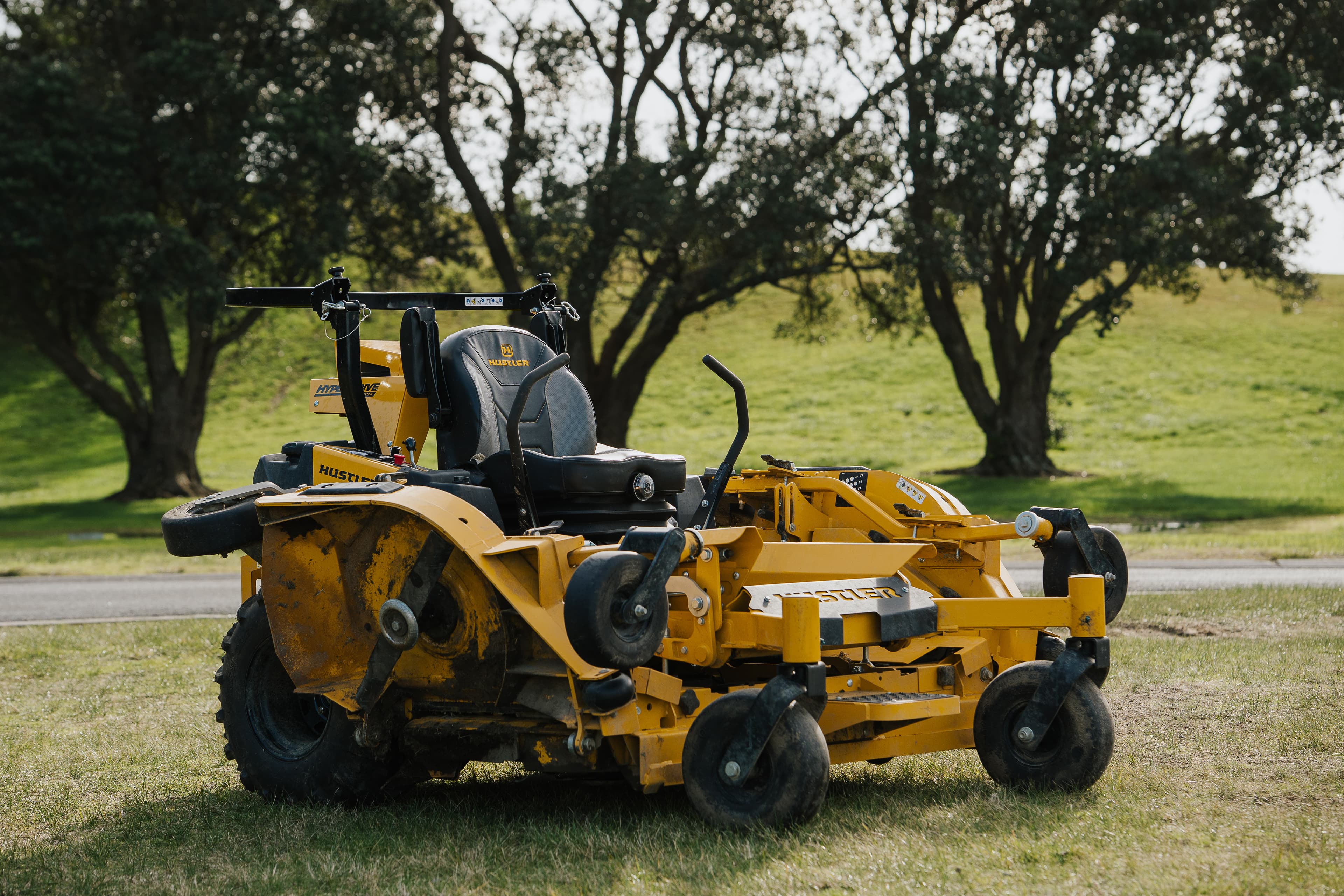 Bea the Hustler ride-on mower, side profile showing the full 104-inch deck