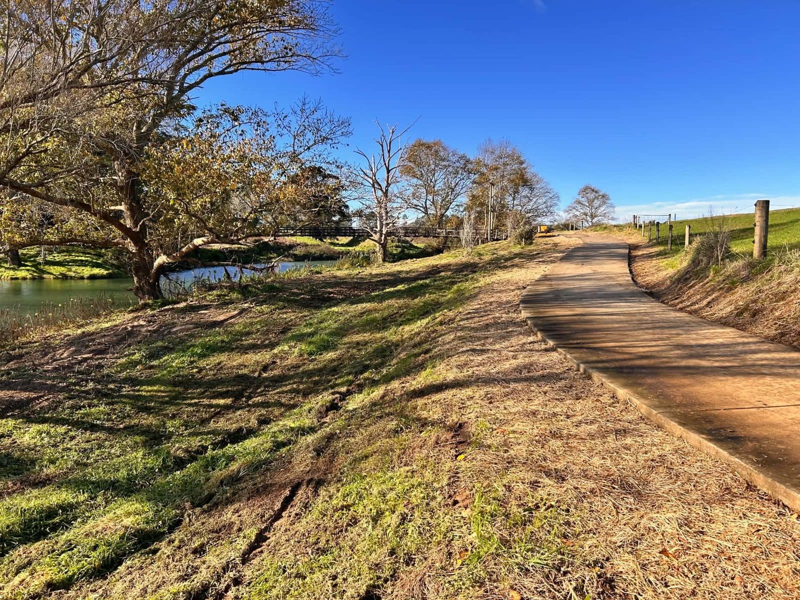 The same riverside walkway with banks mulched clear